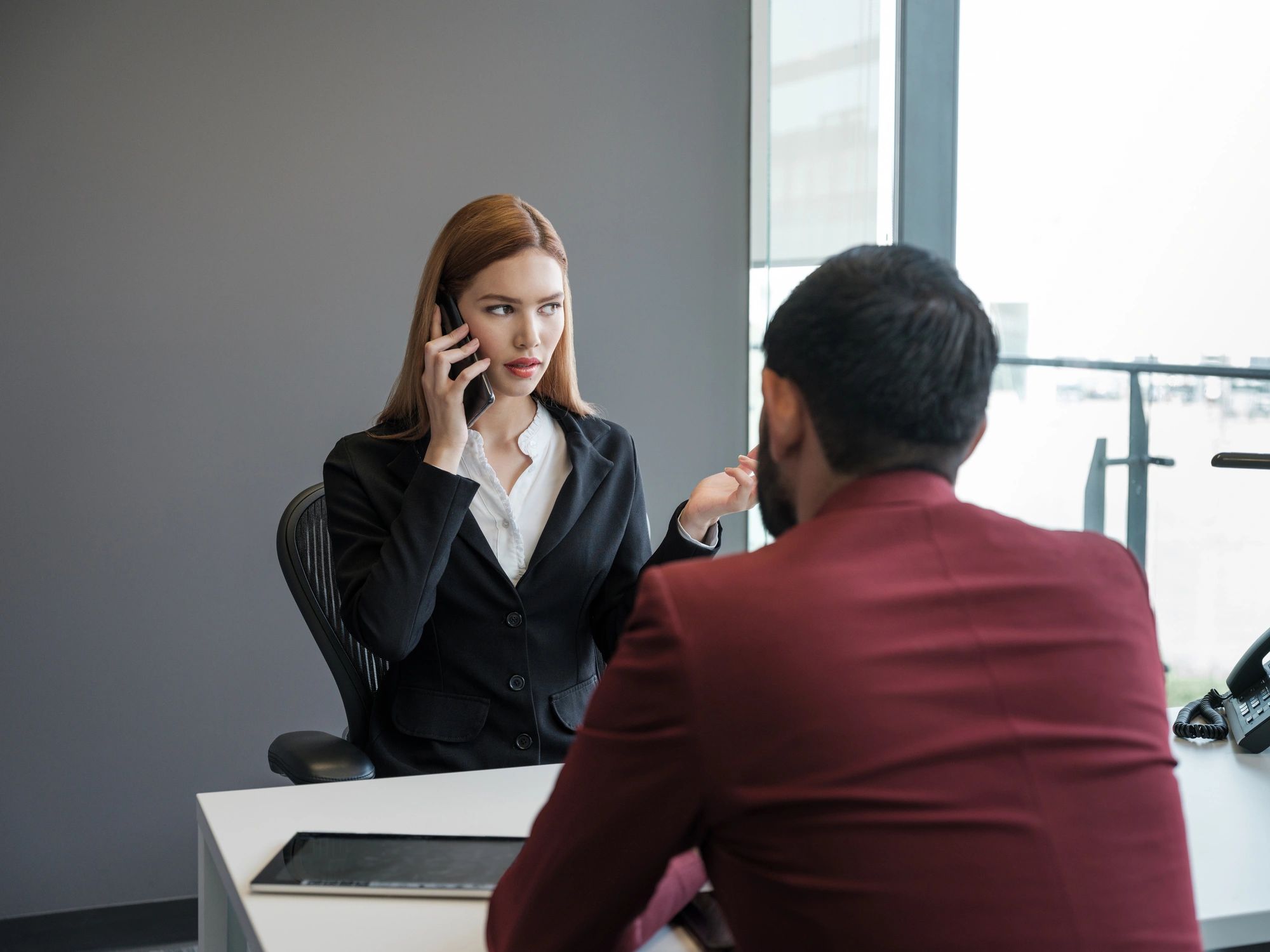 Professional in an office setting on a phone call