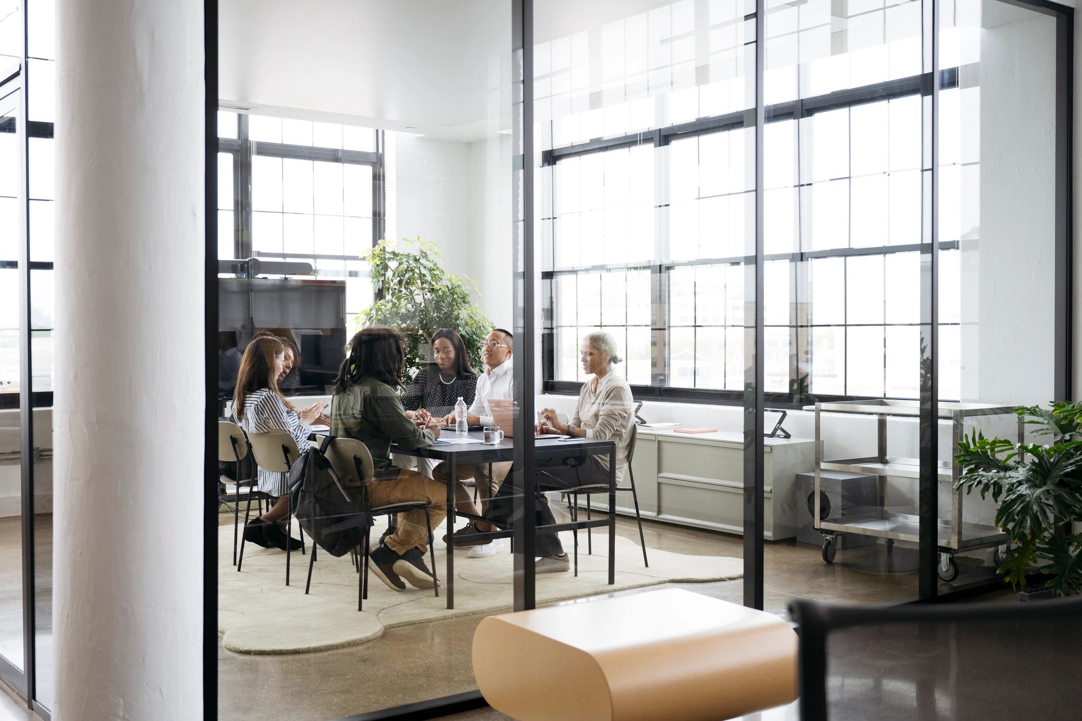 Professionals collaborating around a conference table in a modern office