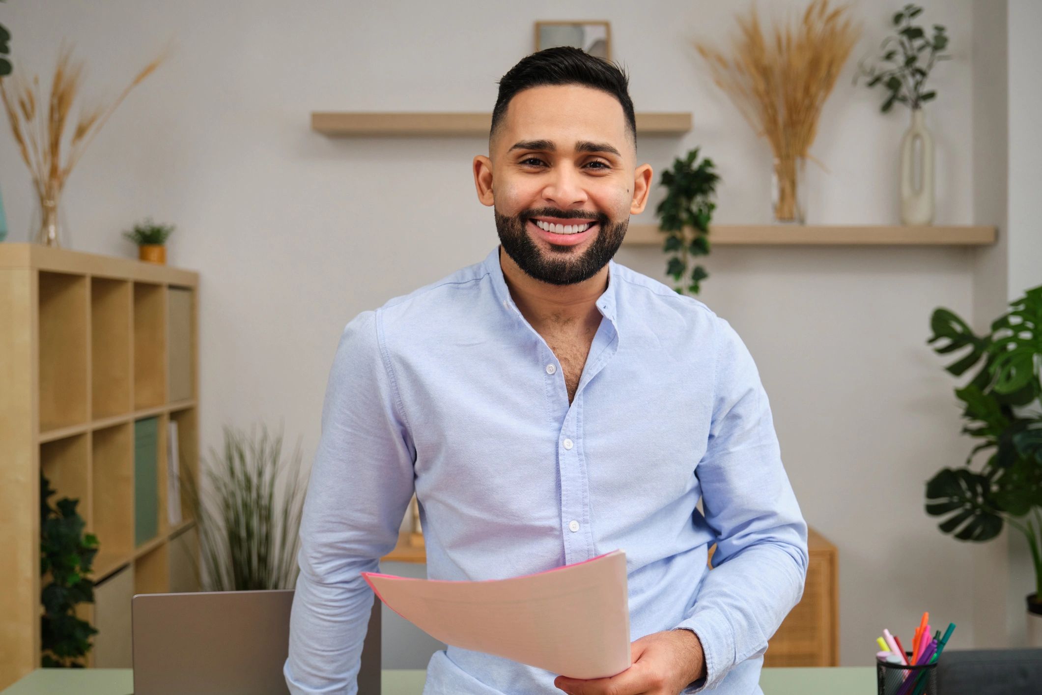 Professional in a home office holding documents